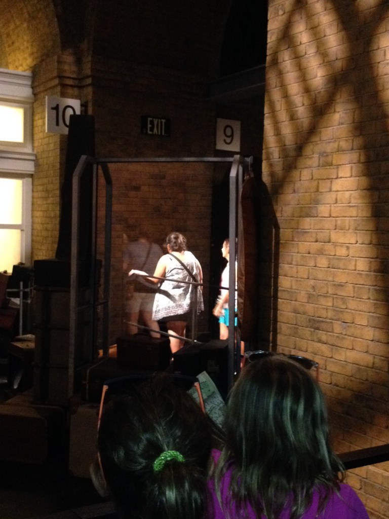 Walking through the wall at Platform 9 3/4 Universal Studios